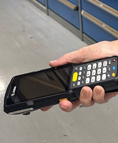 person holding bar code scanning device